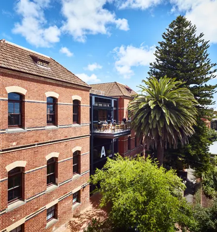 Photo of back of building A at SMB Campus with trees next to the building.