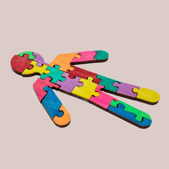 Photo of a human silhouette made of colourful puzzle pieces.